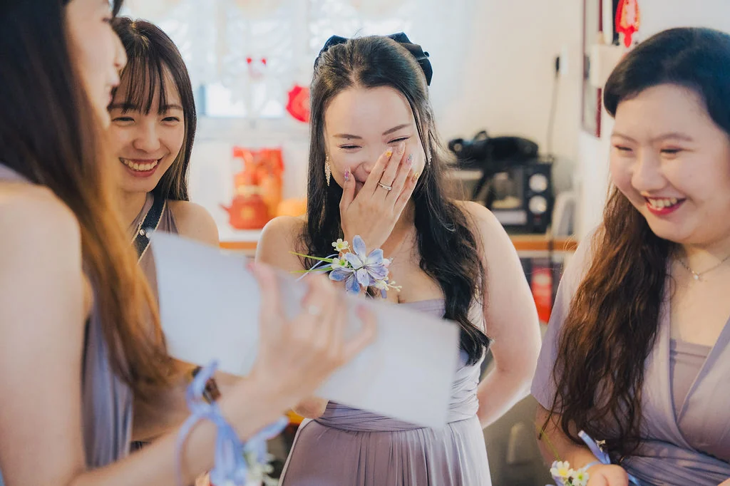 Friends sharing a laugh during Darren and Jerrice’s wedding preparations