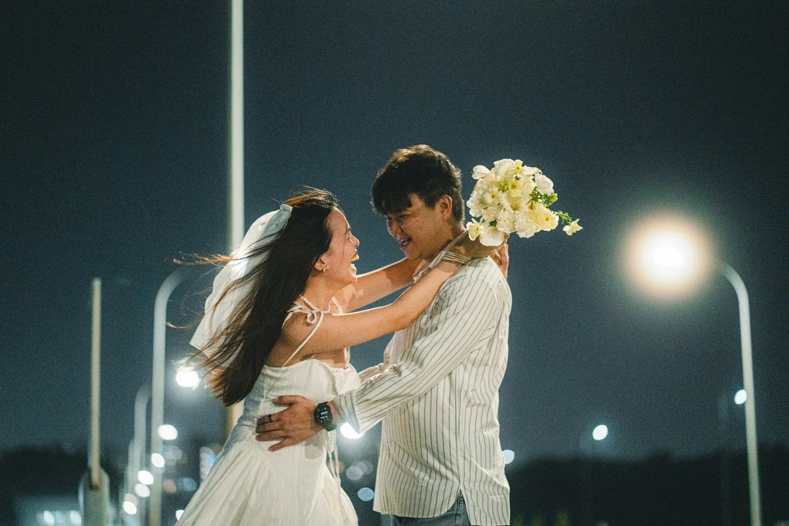 Darren and Ziyi together under the lights at night