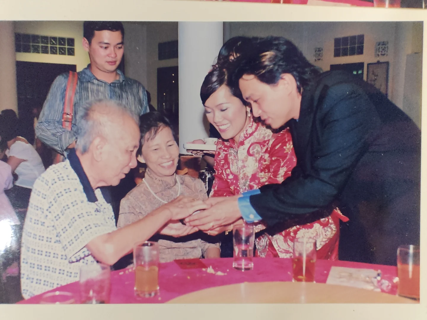 An older photograph of a wedding tea ceremony with family