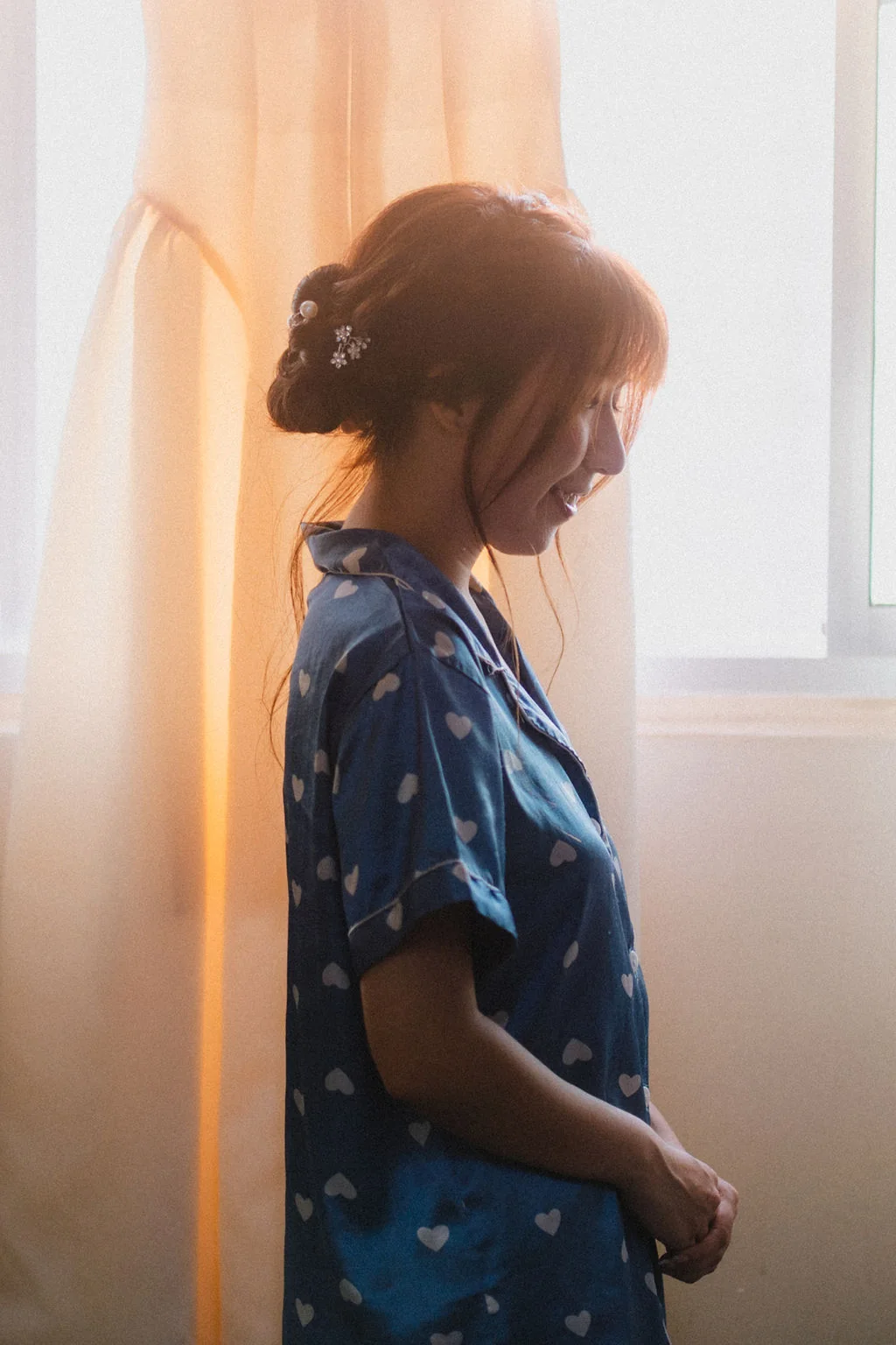 Belle beside a softly lit window