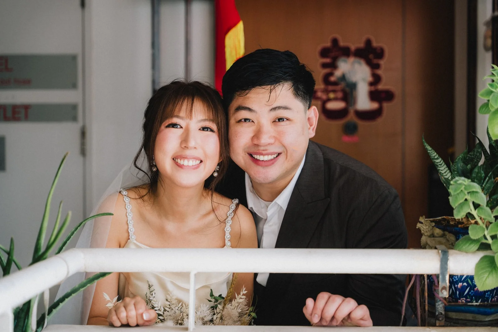 Jason and Belle smiling together at a doorway