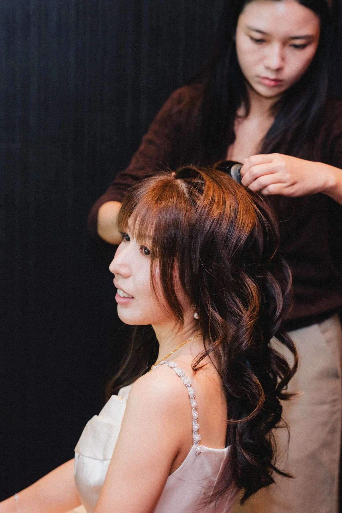 Belle having her hair styled before the next part of the celebration