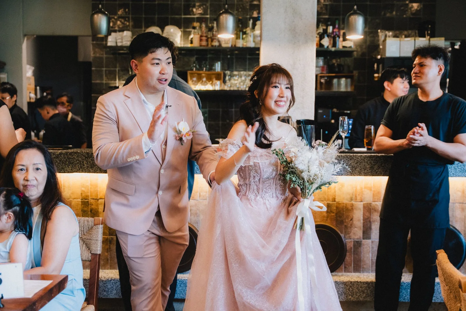 Jason and Belle entering their celebration hand in hand