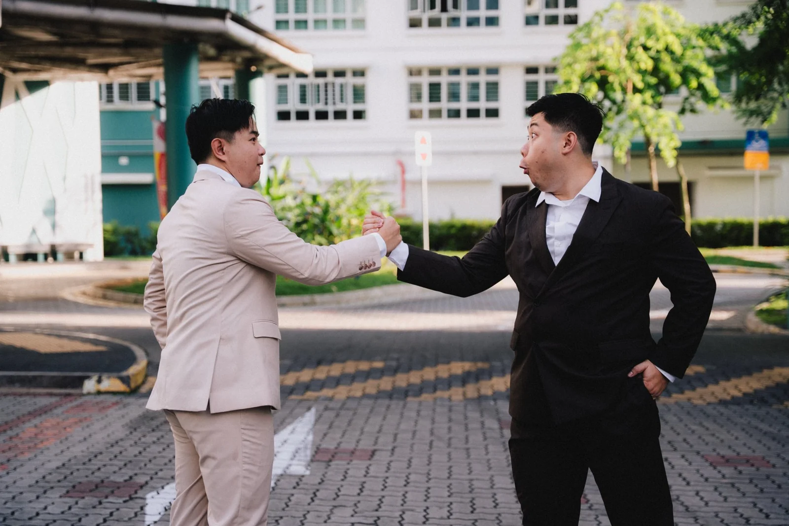 Jason greeting a friend with a handshake outside
