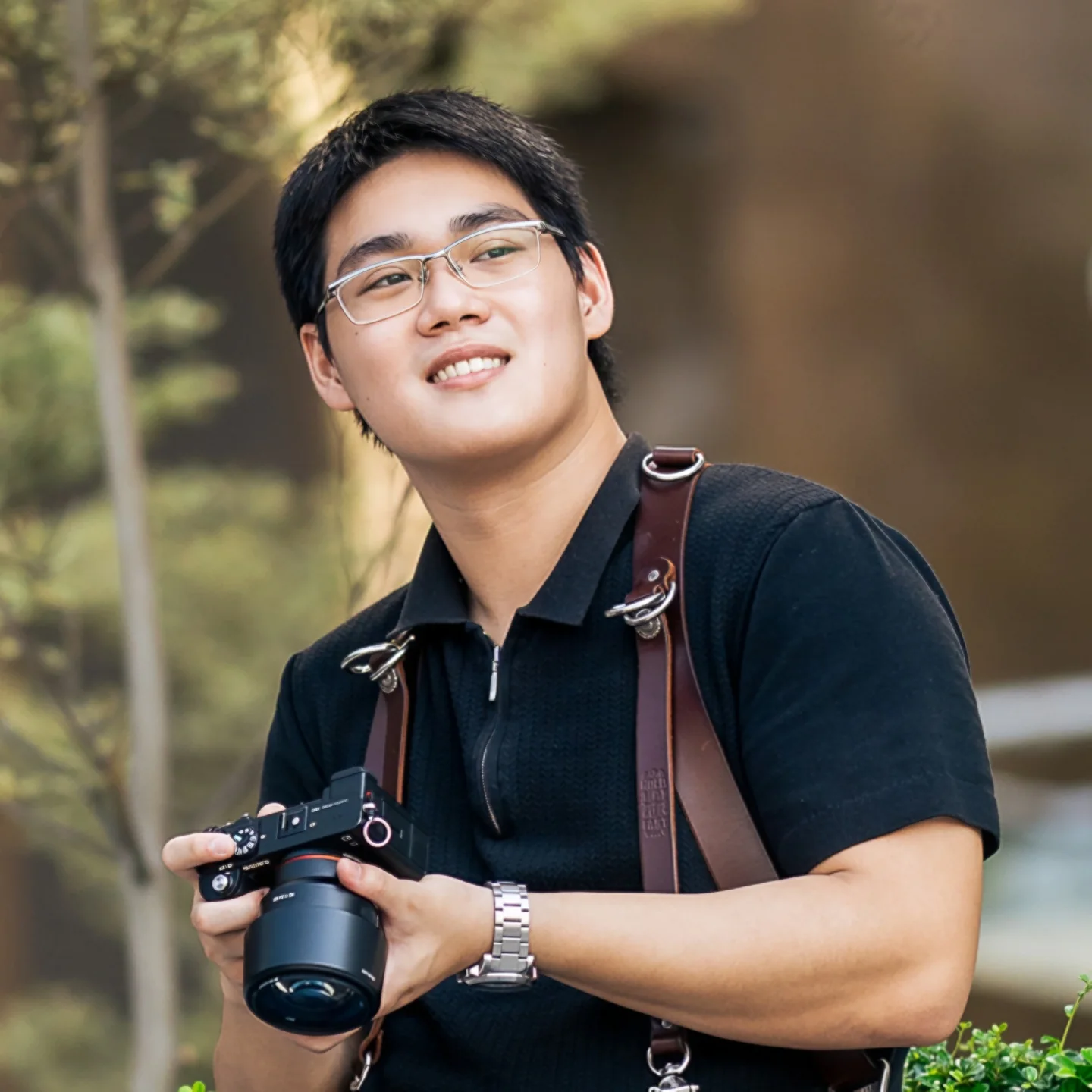 Jason Sng smiling with his camera