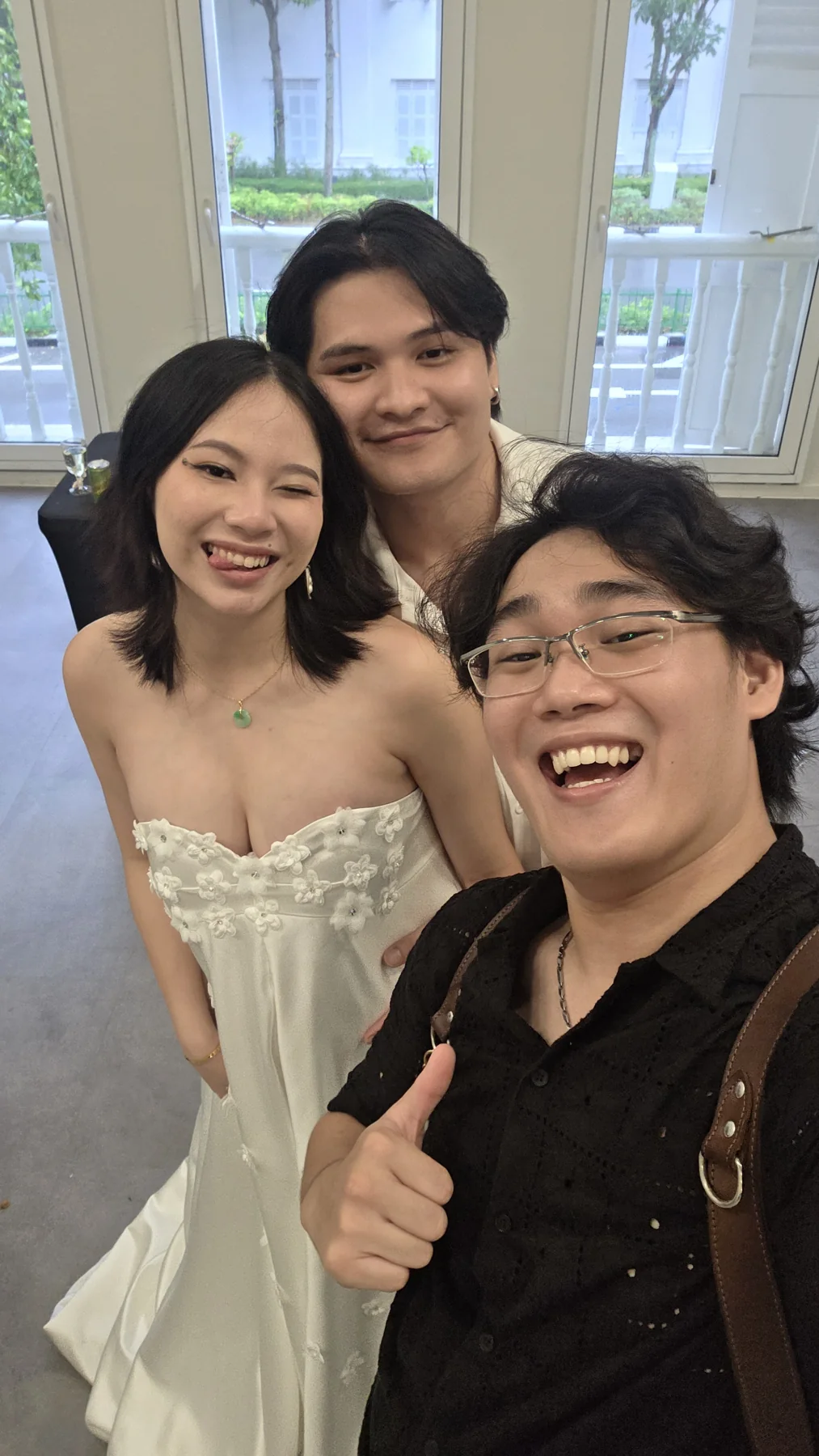 Jason taking an informal photograph with a couple