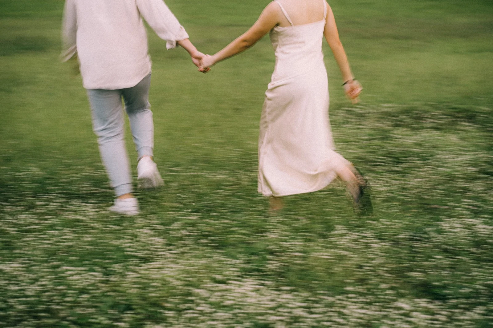 Wee Hung and Ler walking hand in hand through the grass